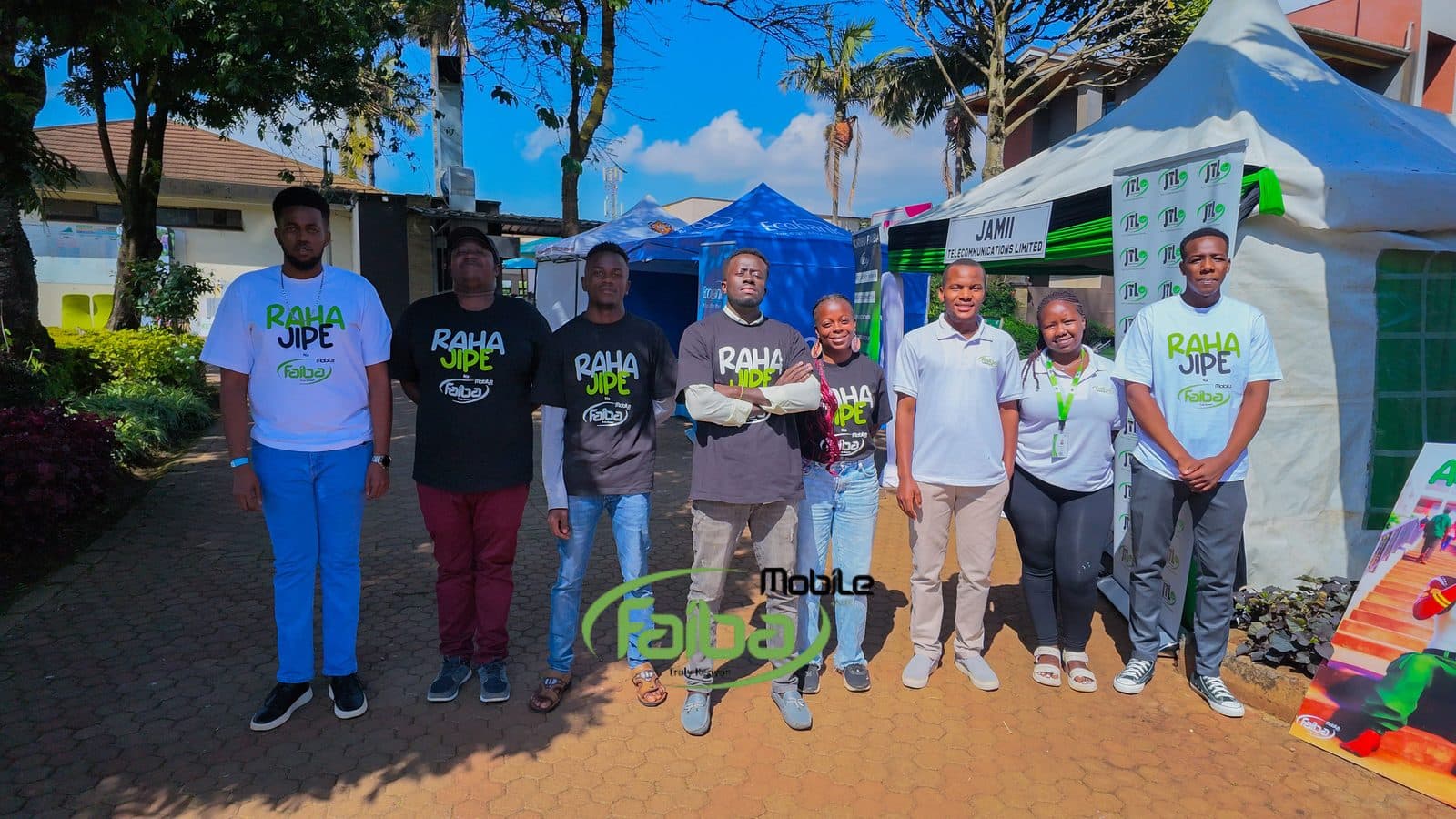 The JTL team in Raha Jipe shirts outside the Jamii Telecommunications tent at the tournament