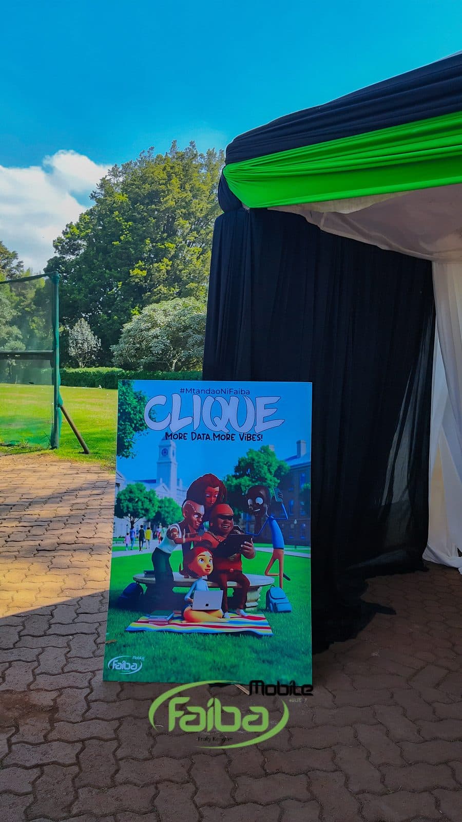 A Faiba Clique poster reading More Data More Vibes beside a branded marquee at the course