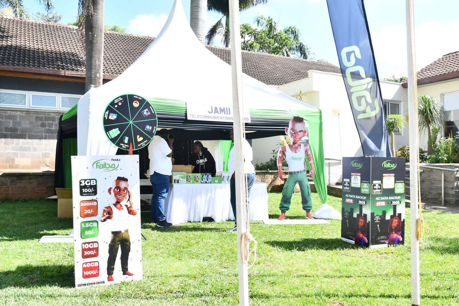 The Jamii Telecommunications tent at the tournament, with a prize wheel and standees advertising Faiba data bundles from 20 shillings