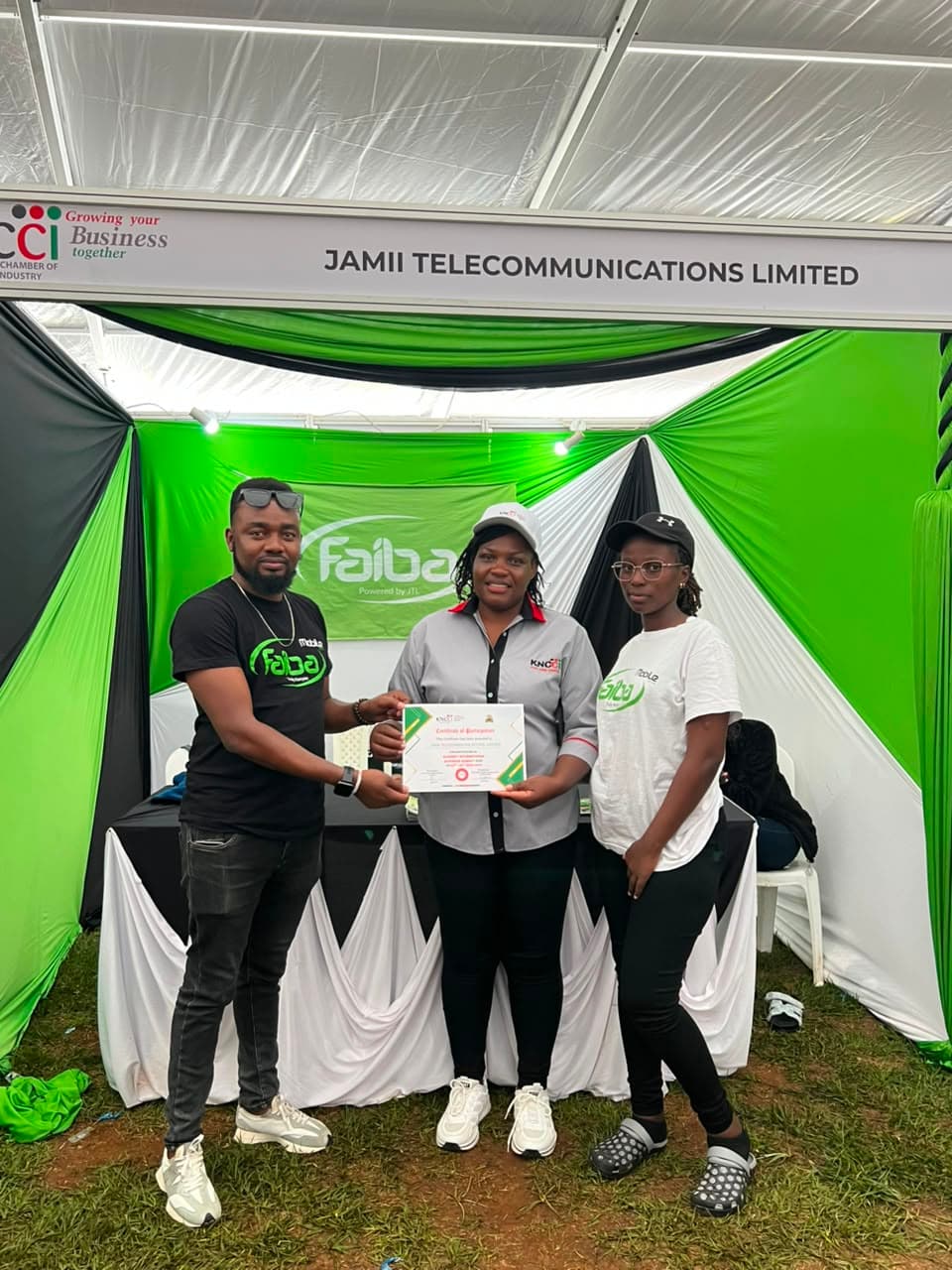 Our Team Lead Antony Matheka (left) & Purity Njeri (right) Receive an award from KNCCI's Lilian Bittok on behalf of JTL